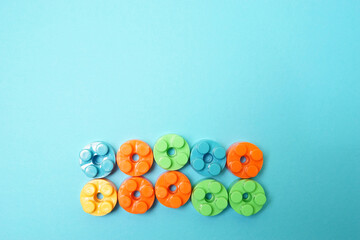 Plastic building blocks isolated on blue background. Top view with copy space