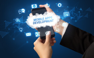 Female hand holding smartphone with MOBILE APPS DEVELOPMENT inscription, cloud technology concept