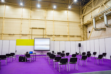 A row of chairs at a business conference