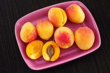Ripe organic apricots in a plate