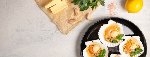 Baked scallops with caviar and creamy garlic sauce. Scallops, lemon, garlic, parsley, butter and salt. Recipe for cooking scallops with caviar. Top view. Copy space.