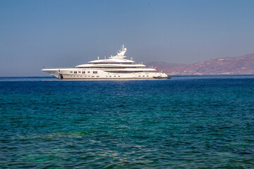 Fototapeta na wymiar Luxury yacht next to downtown of famous Mykonos town (Mykonos island)