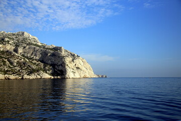 Rocky cliff and its reflection in the blue Mediterranean sea, Parc National des Calanques, Marseille, France