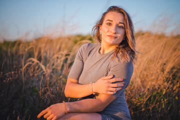 portrait of a beautiful girl in the rays of the sunset