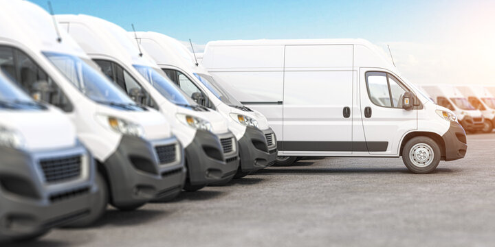 Delivery vans in a row with space for logo or text. Express delivery and shipment service concept.