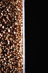 A set of grain cereals. Rice, buckwheat and millet groats in a wooden tray. A grocery set of cereals. Import of grain.