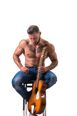 Portrait of muscular man with tattoo playing guitar. Isolated on white background. Full length shot