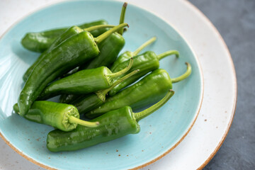 Group of green fresh chilli peppers padron on a plate