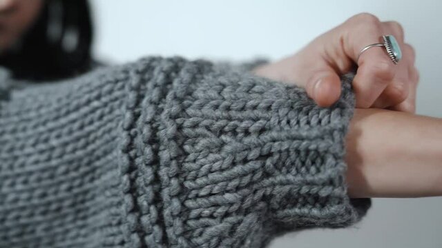 Close up Shot of Female Arms Getting Dressed in a Sweater. Slow Motion Fashion Video