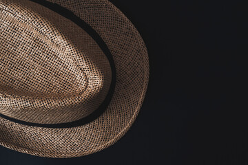 Vintage men's sun hat on a black background. The concept of vacation, vacation, travel, sales, black Friday.