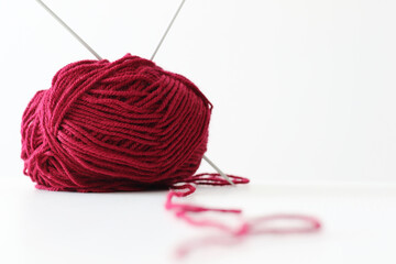 ball or red wool yarn and knitting needles
