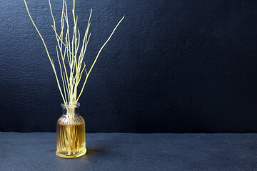 luxury scented aroma room fresherner reed diffser sticks glass bottle with black fiber sticks is on...