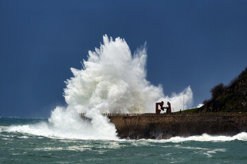 Fototapeta na wymiar Wave caused by big storm crashing coastline in San Sebastian Donostia