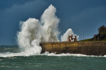 Fototapeta na wymiar Wave caused by big storm crashing coastline in San Sebastian Donostia