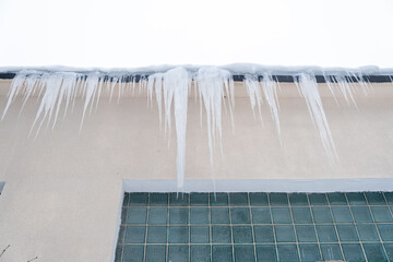 icicles on the roof, winter day, bottom view.