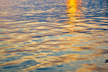 Colorful water surface with ripples at sunset