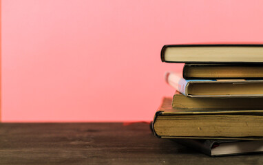 Stacked books on pink background