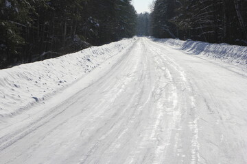 the surface of the road rolled by cars is slippery because of the ice