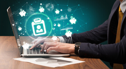 Fototapeta premium Business hand working on laptop with folder holder icons coming out from the screen, successful business concept