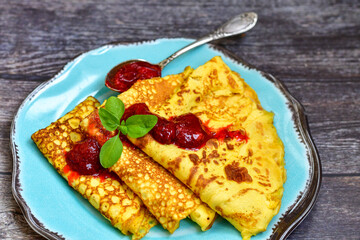 Bakery. Home made pancakes with   organic  bio eggs and home made  strawberry jam  on wooden background. Rustic style breakfast