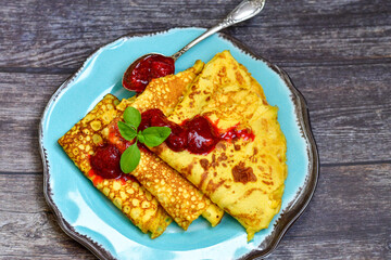 Bakery. Home made pancakes with   organic  bio eggs and home made  strawberry jam  on wooden background. Rustic style breakfast
