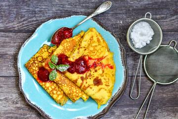 Bakery. Home made pancakes with   organic  bio eggs and home made  strawberry jam  on wooden background. Rustic style breakfast