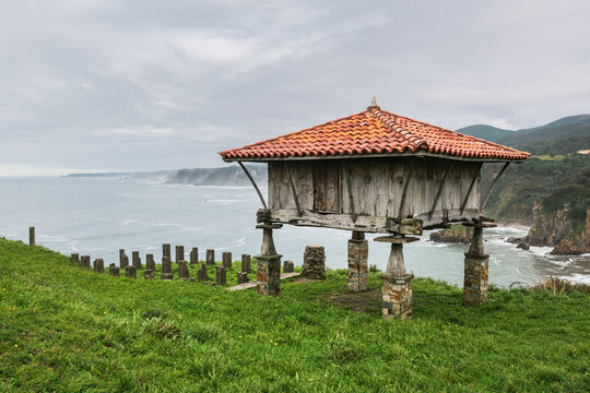 Horreo, a traditional asturian granary built in wood and stone at the cliffs overlooking Cantabrian Sea.