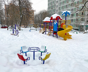 Children's playground covered with snow