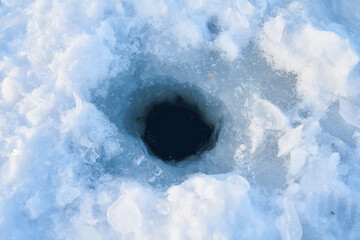 A hole in the ice for ice fishing. The lake hole