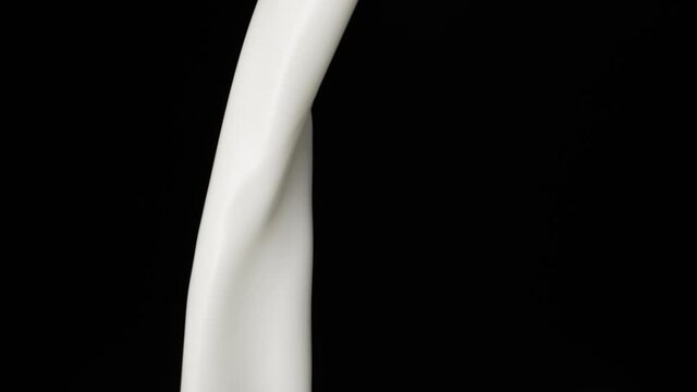 Macro shot of milk stream falling in slow motion