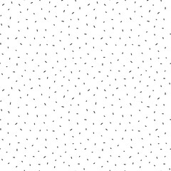 Tiny sprinkle seamless pattern. Black chaotic sticks isolated on white. Repeatable minimalist background.