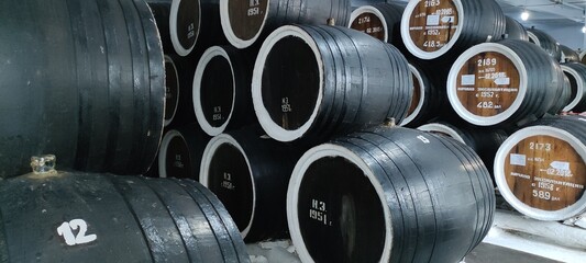 Fototapeta na wymiar Oak barrels with cognac. Extract of grape alcohol