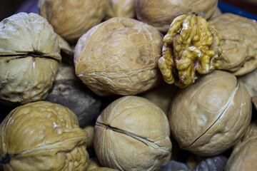 Fototapeta na wymiar Walnuts close up, not peeled walnuts.