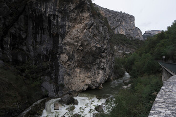 View along the river of the rocks in Pont-en-Royans, in the Auvergne-Rhone-Alps region, during twilight of a winter day.