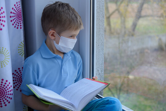 A Sick Boy Wearing A Medical Mask Is Studying At Home In Quarantine. Remote Learning.