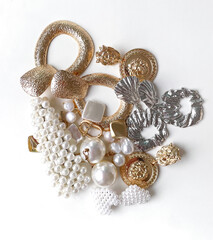 Accessories background. Set of beautiful precious jewelry made of gold, silver, and pearls. Fashion photos