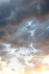 Naklejka na ściany i meble Stratocumulus of clouds at sunset. Sky.