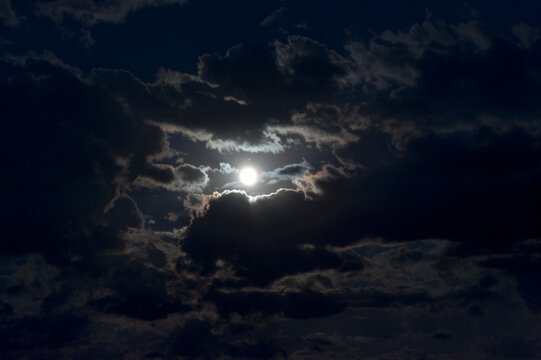 A full moon’s glow in the sky at night. 