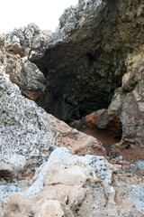 The typical cavernous and calcareous rocks along the Cilento coast. Salerno, Italy, Europe.