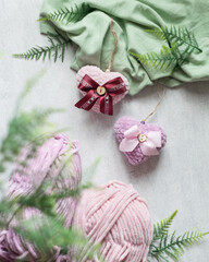 Two love knitted hearts on grey background, valentines day card concept