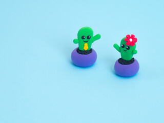 Fototapeta premium Funny plasticine toys on the blue background with copy space