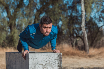 Mexican man doing push ups outside
