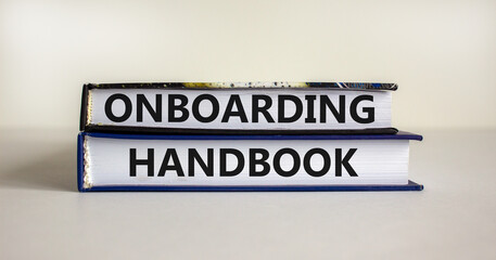 Onboarding handbook symbol. Books with words 'onboarding handbook' on beautiful white background. Business and onboarding handbook concept. Copy space.