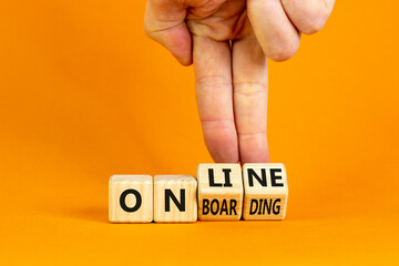 Online onboarding symbol. Businessman turns wooden cubes with words 'online onboarding'. Beautiful orange table, orange background, copy space. Business, online onboarding concept.