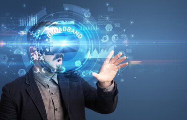 Businessman looking through Virtual Reality glasses with BROADBAND inscription, innovative technology concept