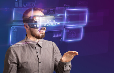 Businessman looking through Virtual Reality glasses with DIGITAL WORKFLOW inscription, new technology concept
