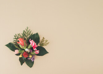 spring flowers on a pastel background. Romantic colorful flowers, roses, green leaves .   Minimal flat lay concept with copy space.