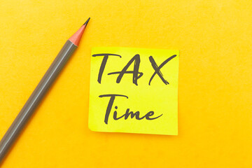Tax time - Notification of the need to file tax returns with pencil on yellow background