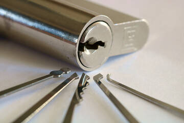 A Euro Lock surrounded by a selection of different lock picking tool.