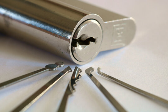 A Euro Lock surrounded by a selection of different lock picking tool.